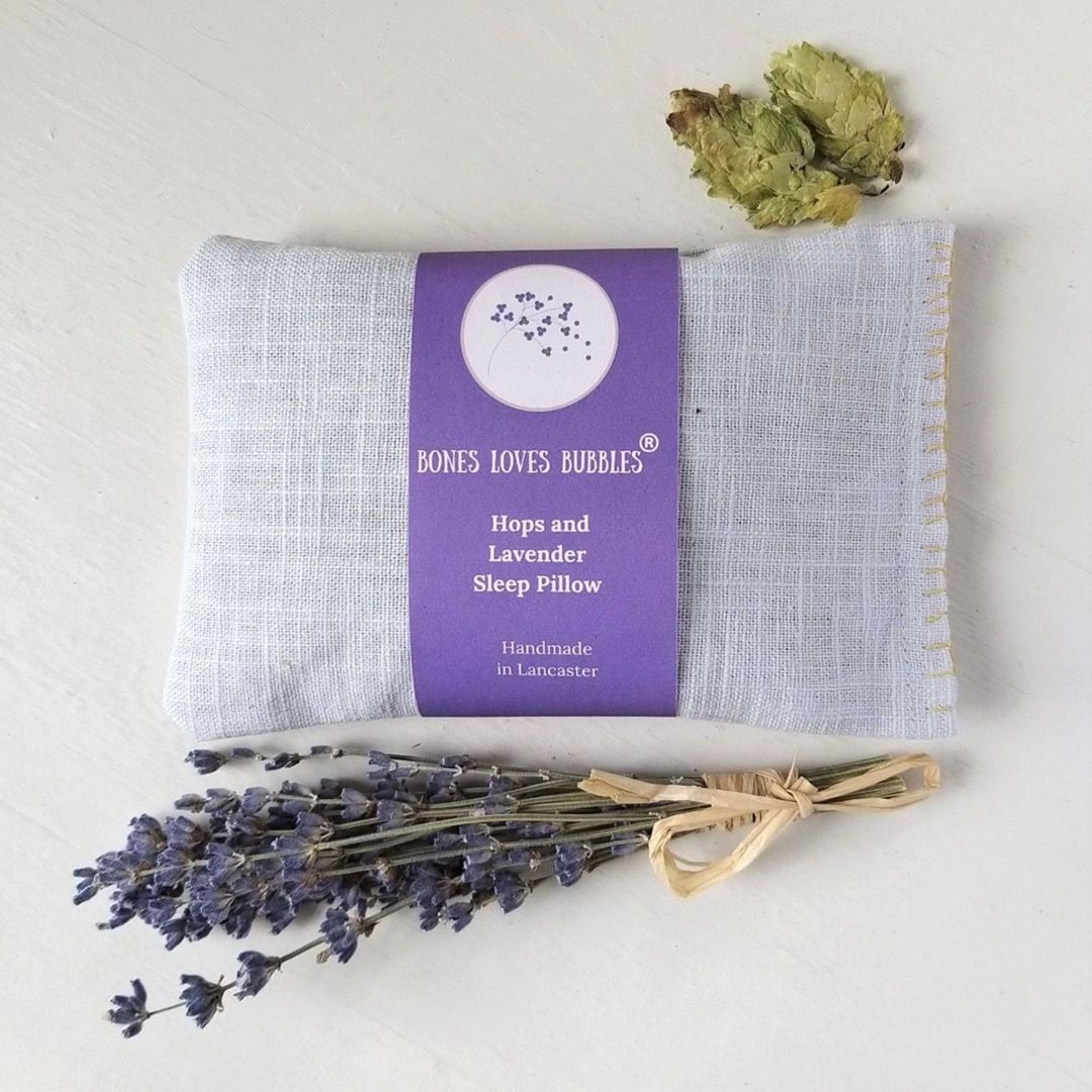 A lavender bag featured next a sprig of lavender