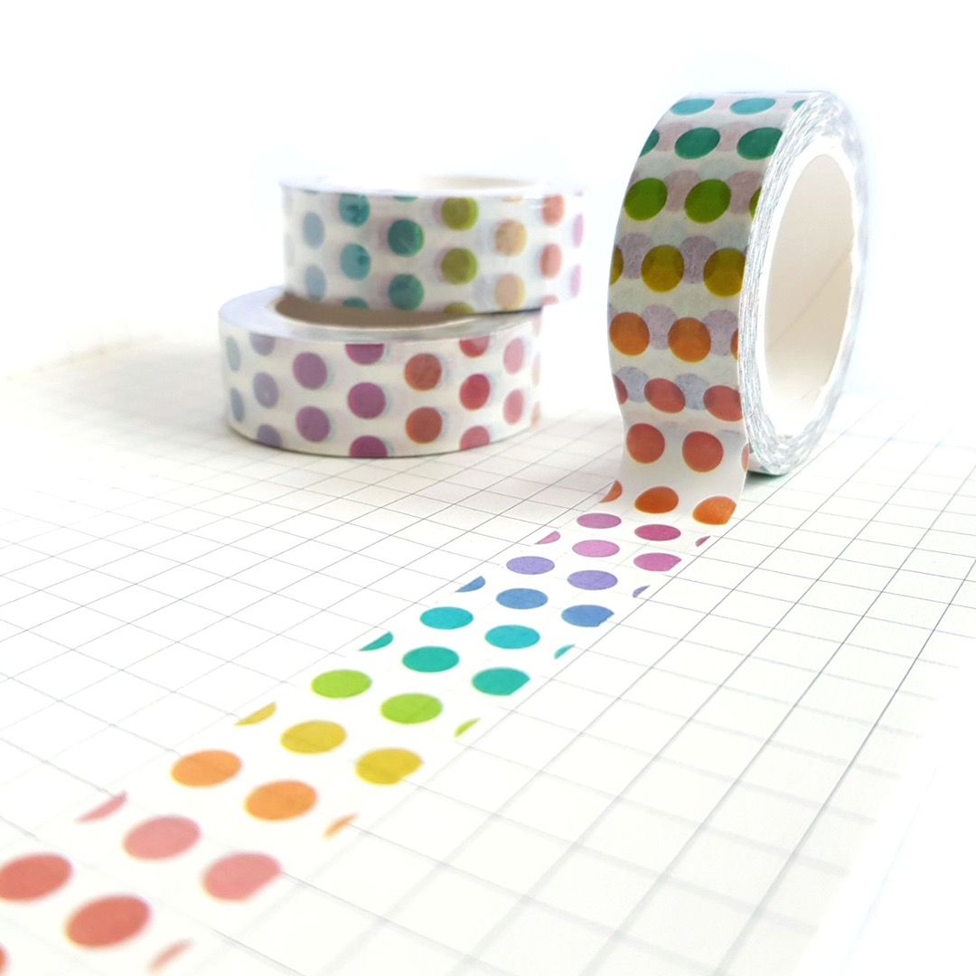 Three rolls of washi tape featuring a rainbow polka dot pattern