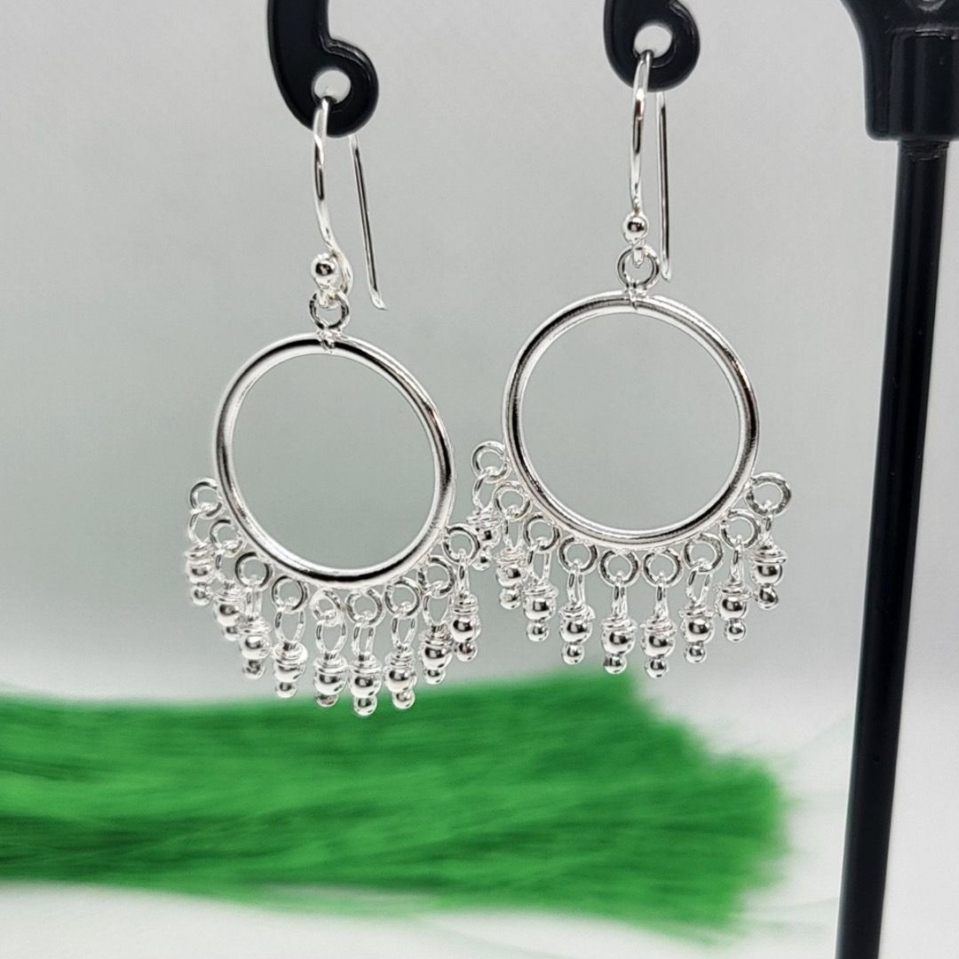 Two hoop earrings with dangling beads in a chandelier effect