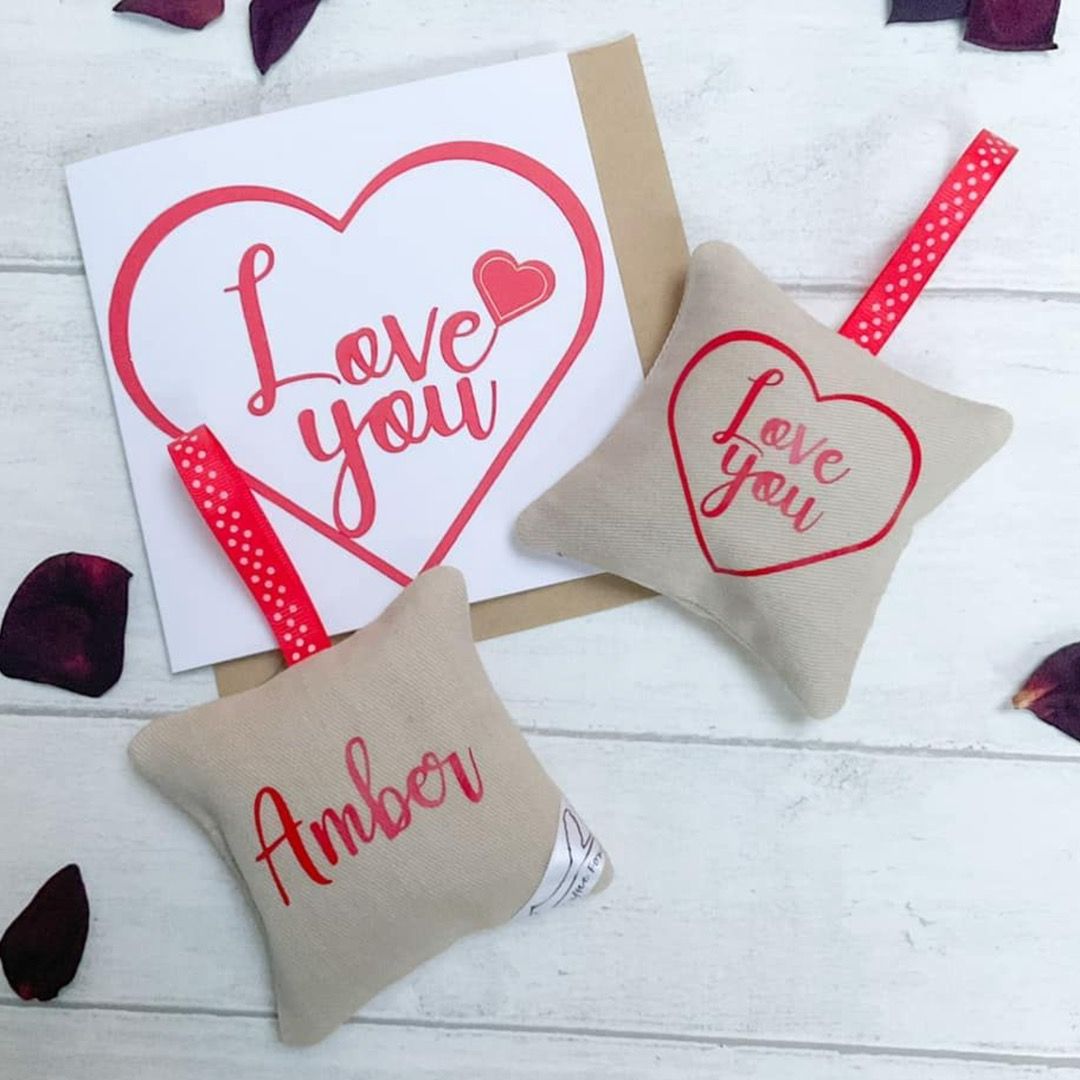 Two lavender bags. One with Amber written on it, the other with "Love you" in a heart