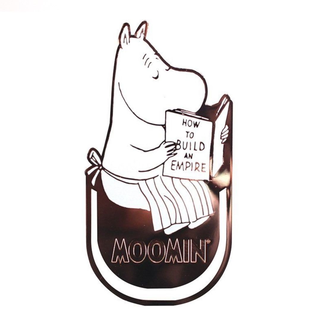 A metal bookmark featuring a moomin reading "How to build an empire"