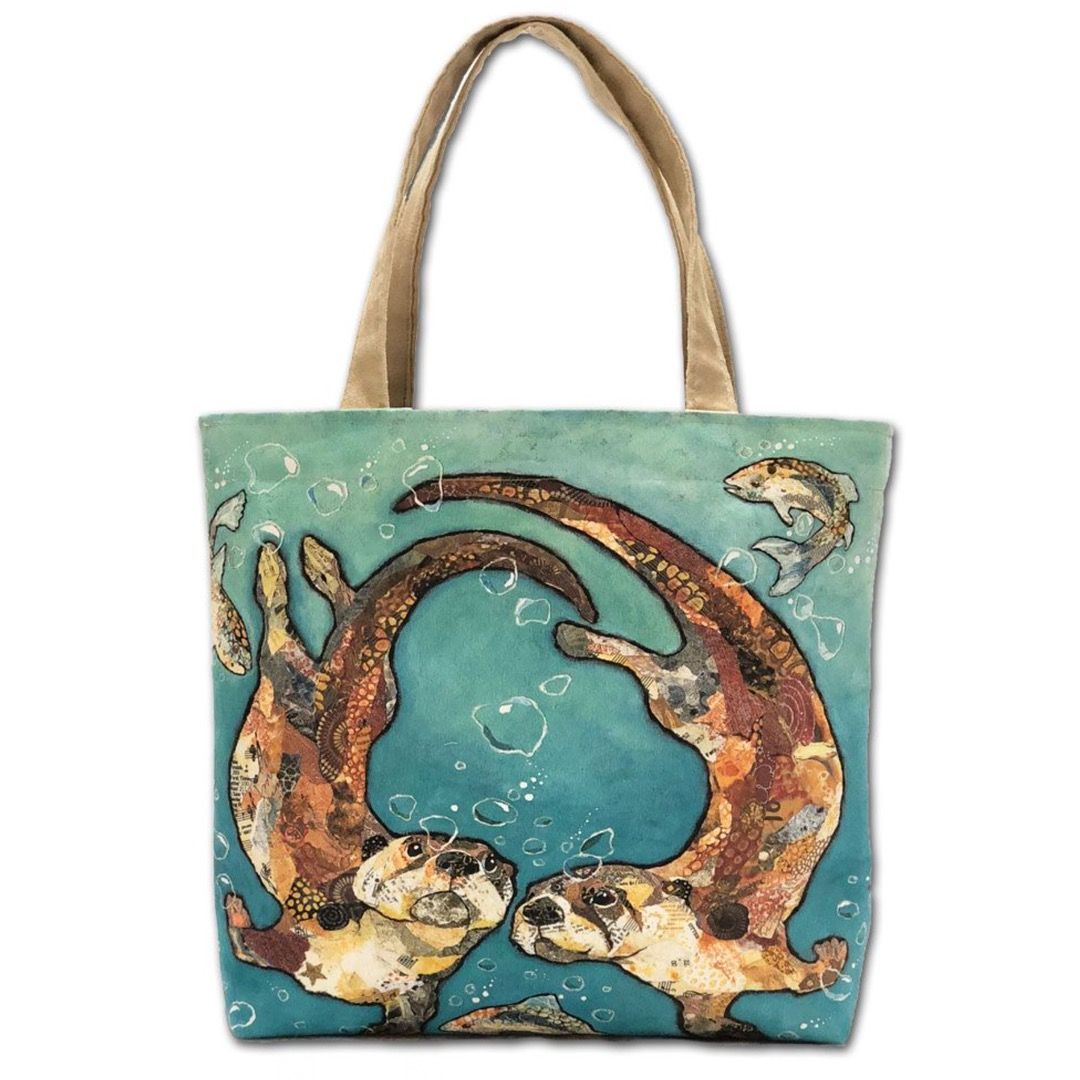 A tote bag featuring two swimming otters in Dawn Maciocia's art style