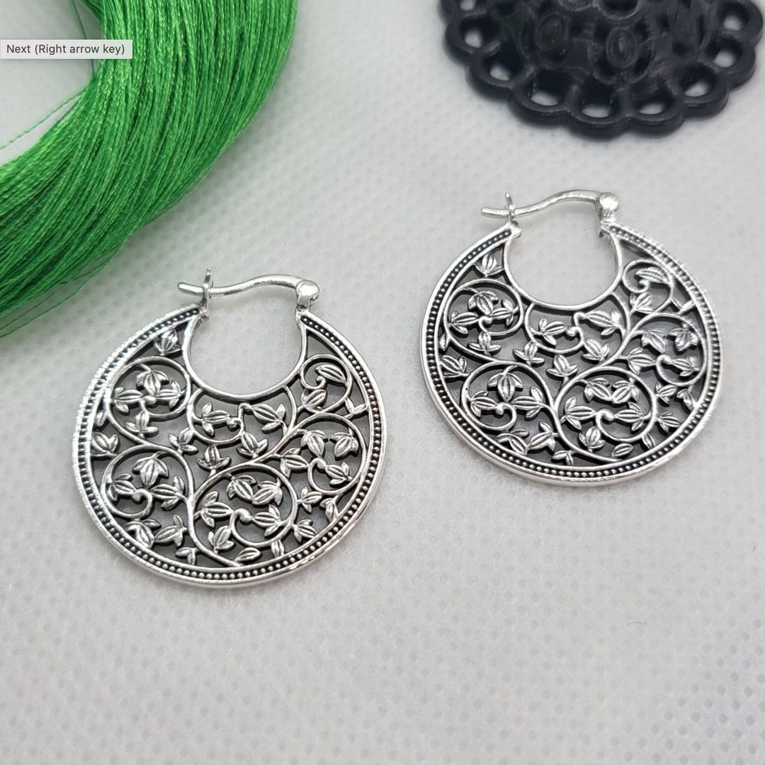 Two hoop earrings with a floral pattern