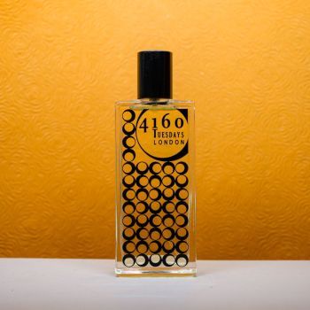The Orange Tree perfume against an orange textured backdrop