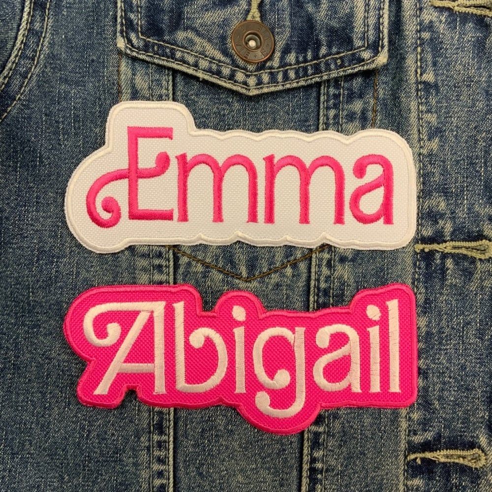 A denim jacket featuring two name patches, Emma and Abigail in a flourish font