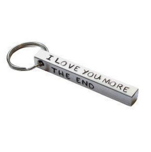 an ingot bar keyring featuring the stamped text "I love you more. The end. I win"