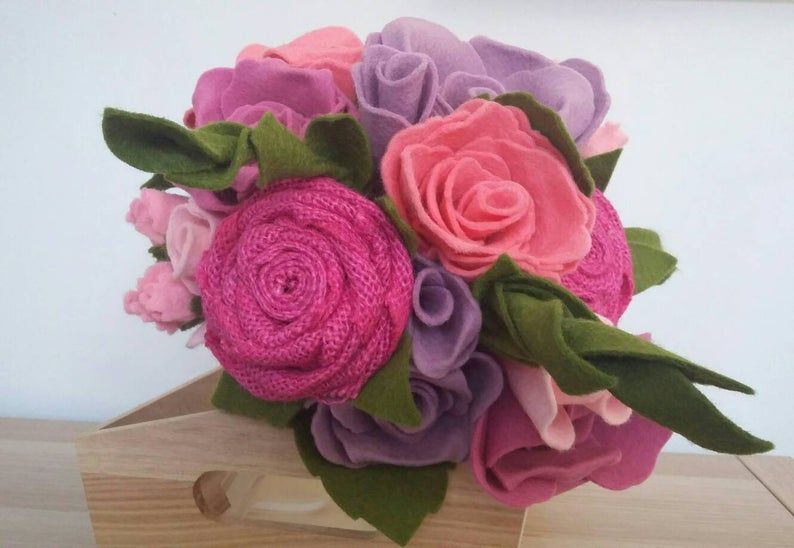 A bouquet of felt roses in different purples