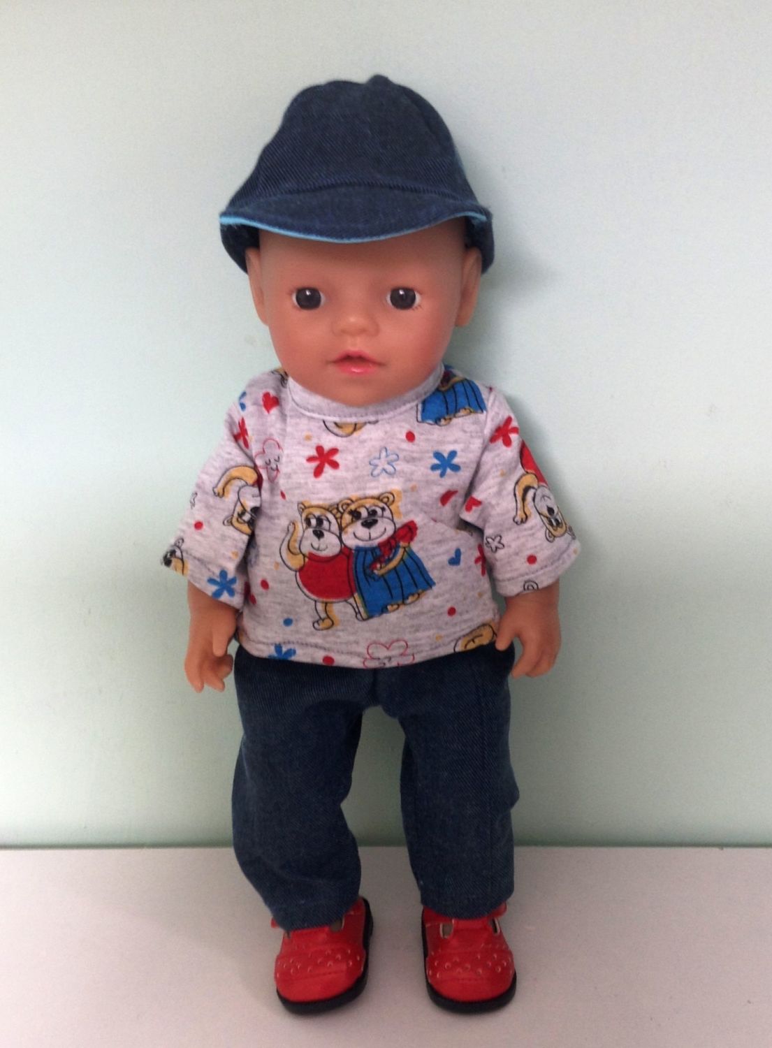 Doll's tee shirt,jeans and peak cap made to fit a 12 inch high baby doll. 
