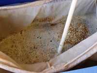 Mixing the grain to avoid any dry spots