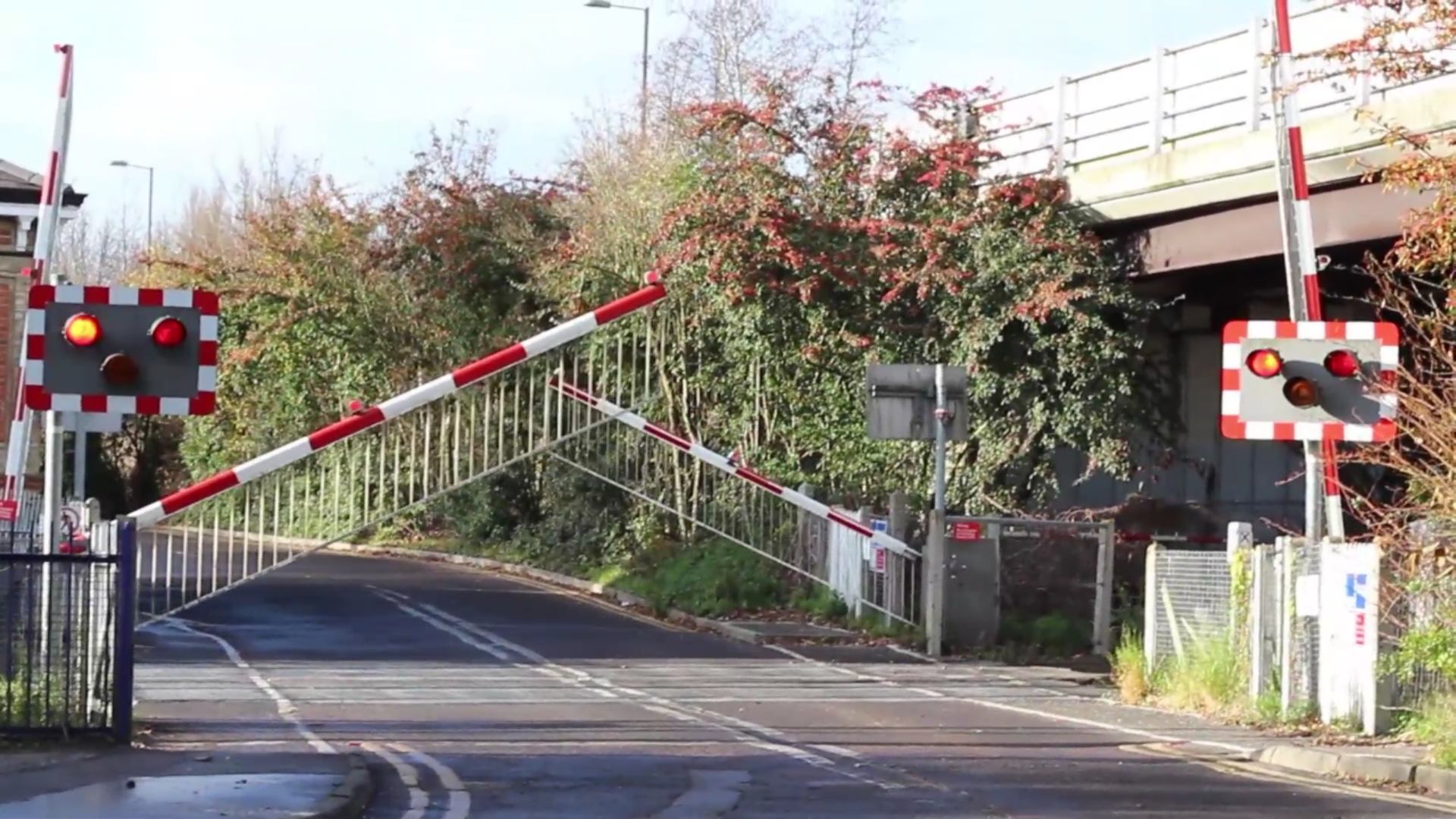 Flashing lights at level crossings are a crucial safety feature designed to alert drivers and pedestrians to the presence of an approaching train.  These flashing lights are typically installed on either side of the level crossing, near the road, and sometimes on additional posts or overhead structures.  They are activated automatically when a train is approaching the crossing. The sequence of flashing lights serves as a visual warning, In general, the lights flash alternately, typically in a red, and they continue to flash until the train has passed and the crossing is safe to use. These lights, along with other warning signals like barriers, bells, and warning signs, are essential in preventing accidents at level crossings by providing clear and unmistakable visual cues to all road users that a train is in the vicinity.