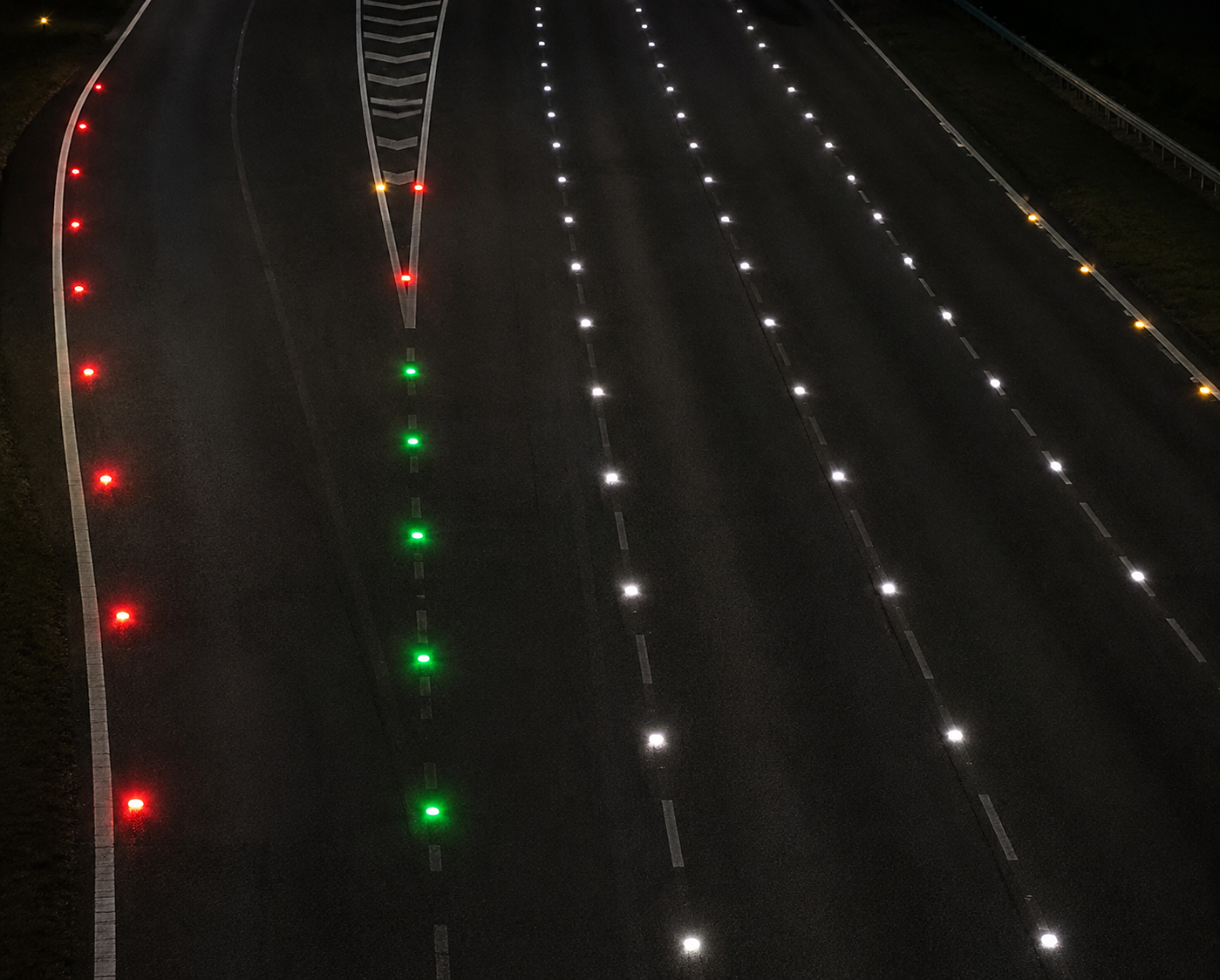 Motorway stud colours Reflective road studs, often called 'Cat's Eyes,' are a vital safety feature that provides drivers with crucial guidance, especially during darkness or poor visibility. A color-coded system is used to convey specific information about the road layout.  White studs are the most common and mark the lanes or the center line of the road, separating traffic streams moving in the same or opposite directions.
