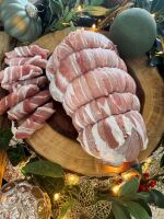 Hand rolled turkey breast topped with dry cured streaky bacon