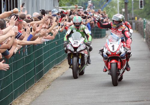 John McGuiness salutes the fans at the end of the Senior TT