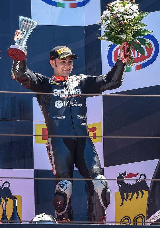 APRILIA ON THE PODIUM WITH LEON HASLAM