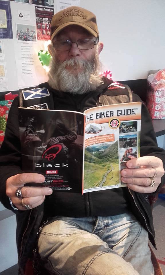 Jock reading THE BIKER GUIDE booklet at Bikers Cove, South Queensferry, Sco