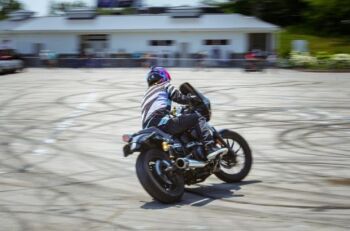 Man riding bike - Urban Splash - A person riding a motorcycle on a parking