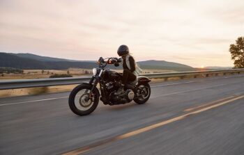 Man on black cruiser motorcycle on highway – Unsplash