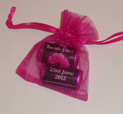 PINK GERBERA ON BLACK BACKGROUND - filled favour with 2 rolls love hearts