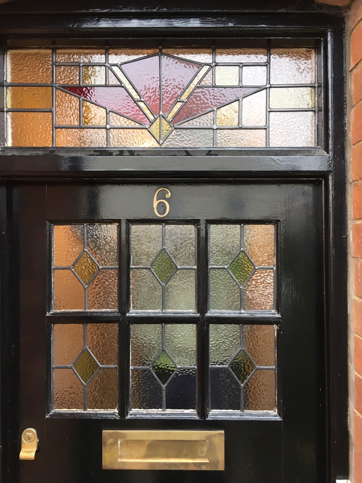 Black front door with stained glass panels