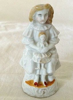 Antique Victorian fairing or Staffordshire figure little girl with toy doll