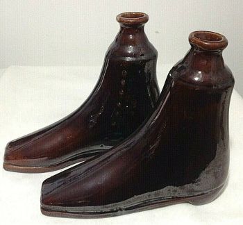 Antique Victorian treacle glazed bottles in the form of boots pair