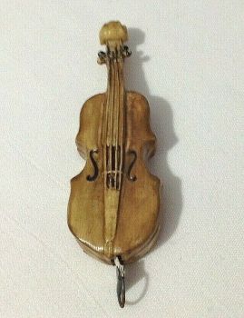 Antique novelty Celluloid tape measure as a musical instrument Cello