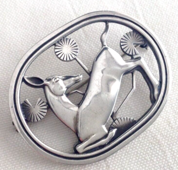 A Georg Jensen sterling pierced oval ‘Kneeling Fawn’ brooch designed by Arno Mal