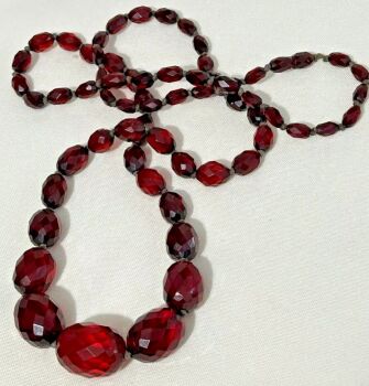 Antique long graduated faceted phenolic cherry amber bead necklace