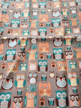 Coated cotton fabric - colourful owls on a brown background
