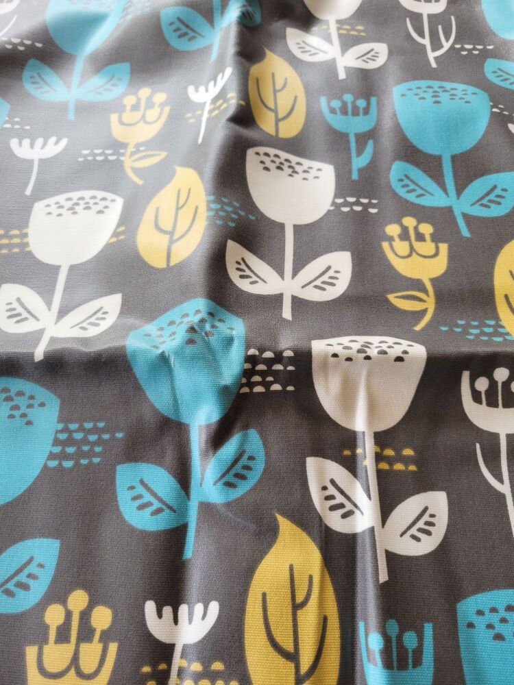 Coated cotton fabric with mixed flowers on a dark background