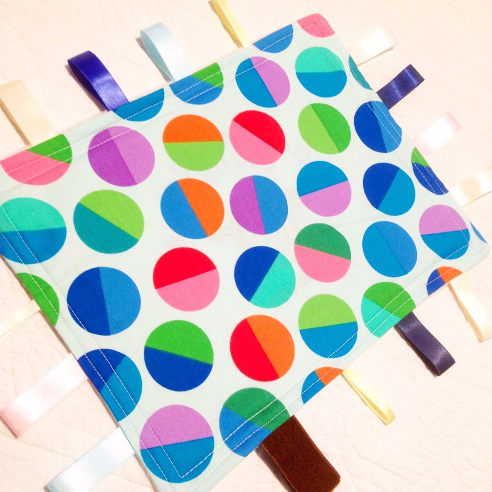 Spotty fabric baby taggy blanket