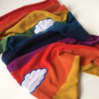 Knitted rainbow with clouds baby blanket