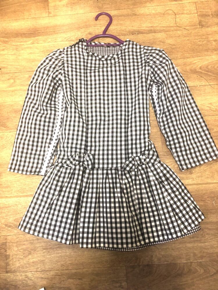 child gingham dress with arm braiding front view child gingham dress with arm braiding front view