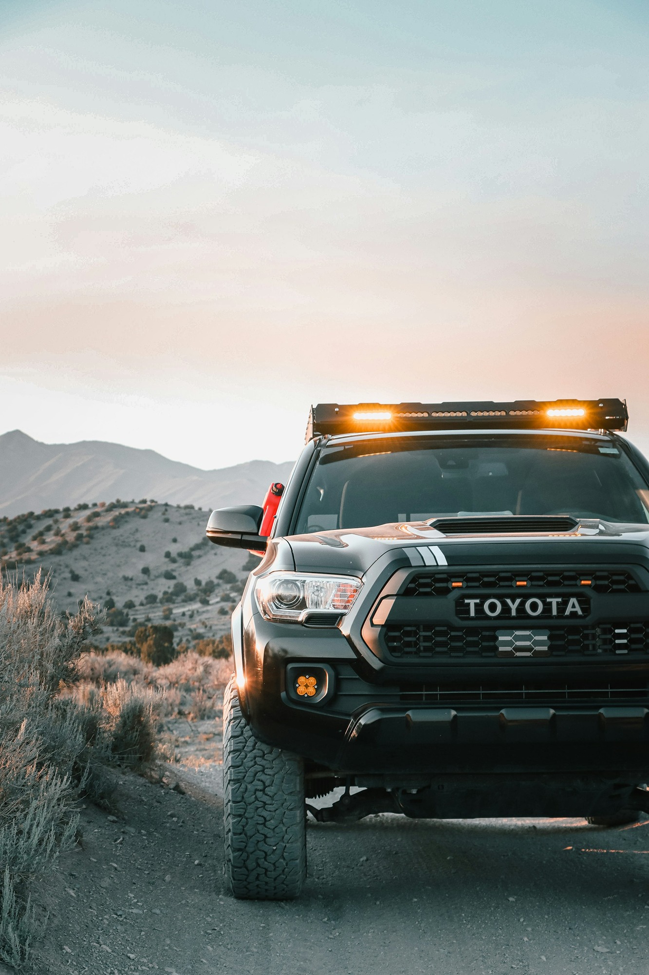 a-toyota-truck-is-parked-on-a-dirt-road-EO5BbCoW7E4