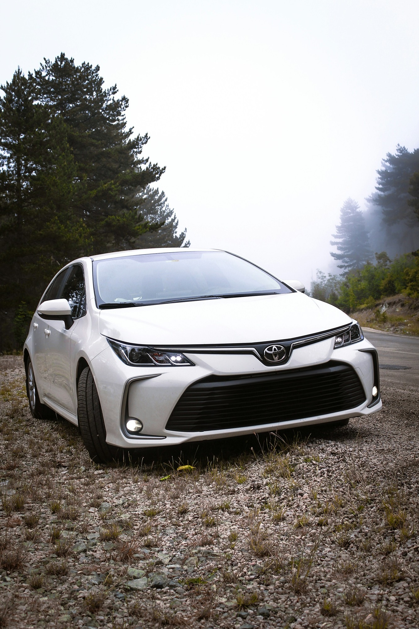 a-white-car-parked-on-the-side-of-a-road-DwNmXuRb1Tk.jpg