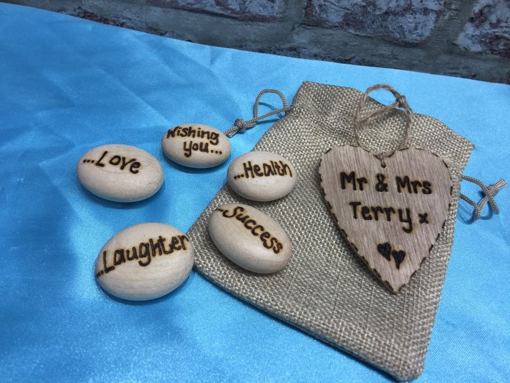 Wooden wish pebbled in a hessian bag