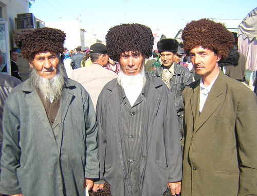 Three Turkmen fellows in traditional hats