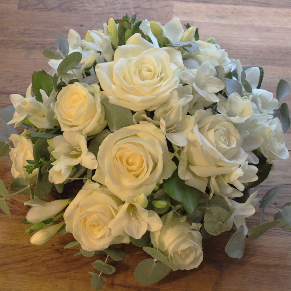 Send a Ivory Rose and Freesia posy funeral flower tribute to Sussex