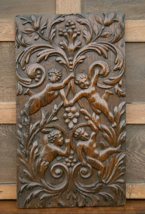 17th Century Flemish Carved Oak Panel Depicting Four Cherubs In Foliate Bor