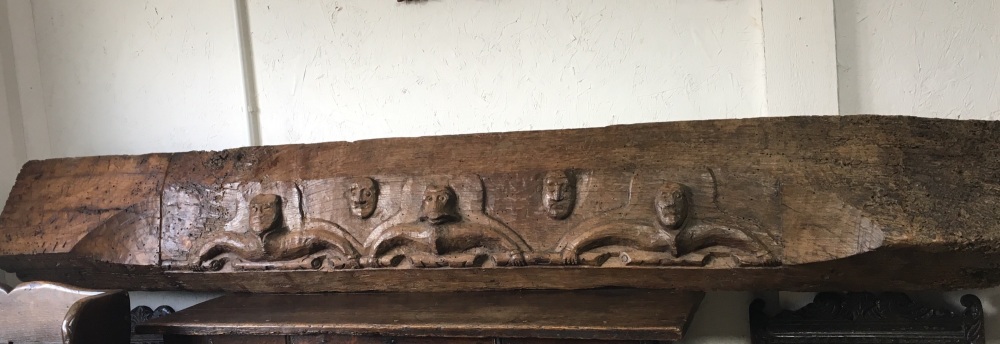 A Rare Early 16th Century Carved Oak Lintel Beam Depicting Four Male Heads And A Monkey Head.