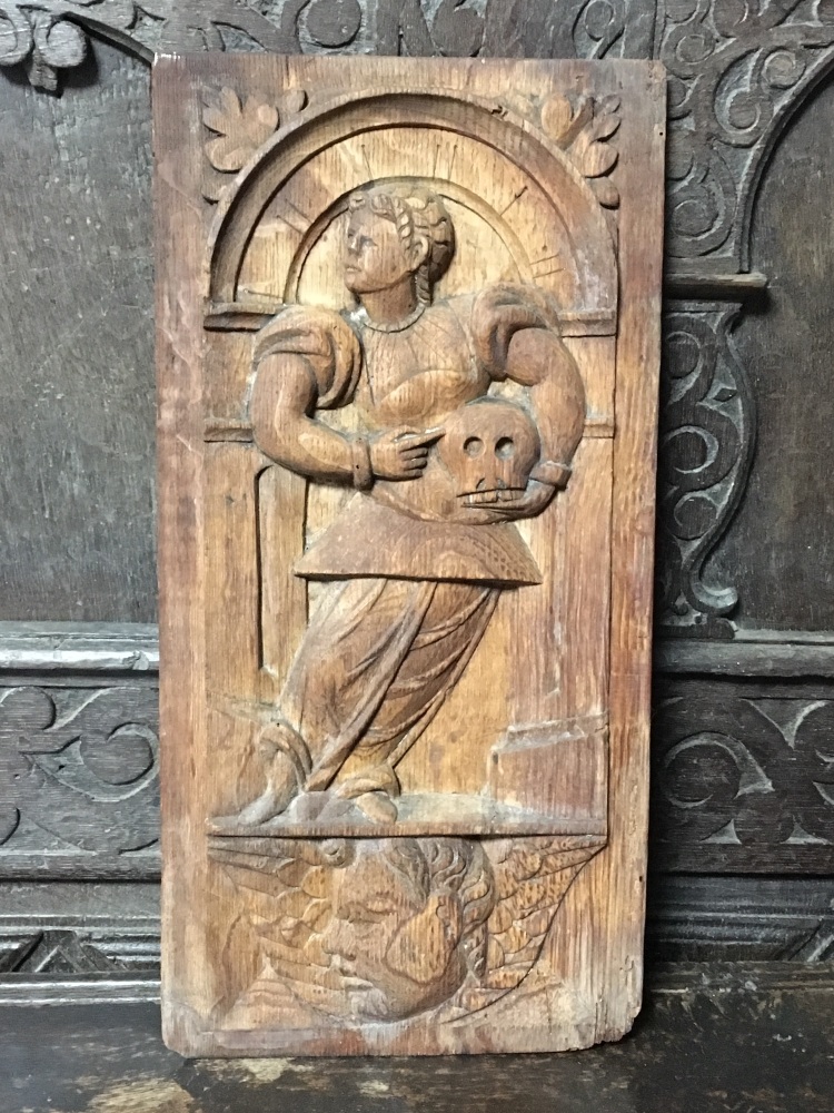 An Early 17th Century Carved Oak Panel Of A Saint Holding A Memento Mori Skull 