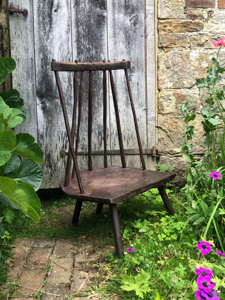 An 18th Century Sculptural Welsh Primitive Fire Side Chair Of Wide Proportions With Original Paint SOLD