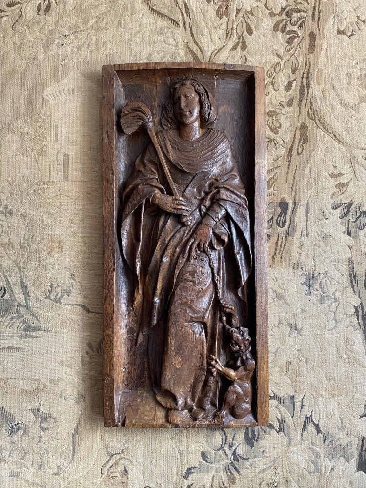 A 16th Century Carved Oak Panel Of St.Juliana With The Chained Devil At Her Feet. SOLD