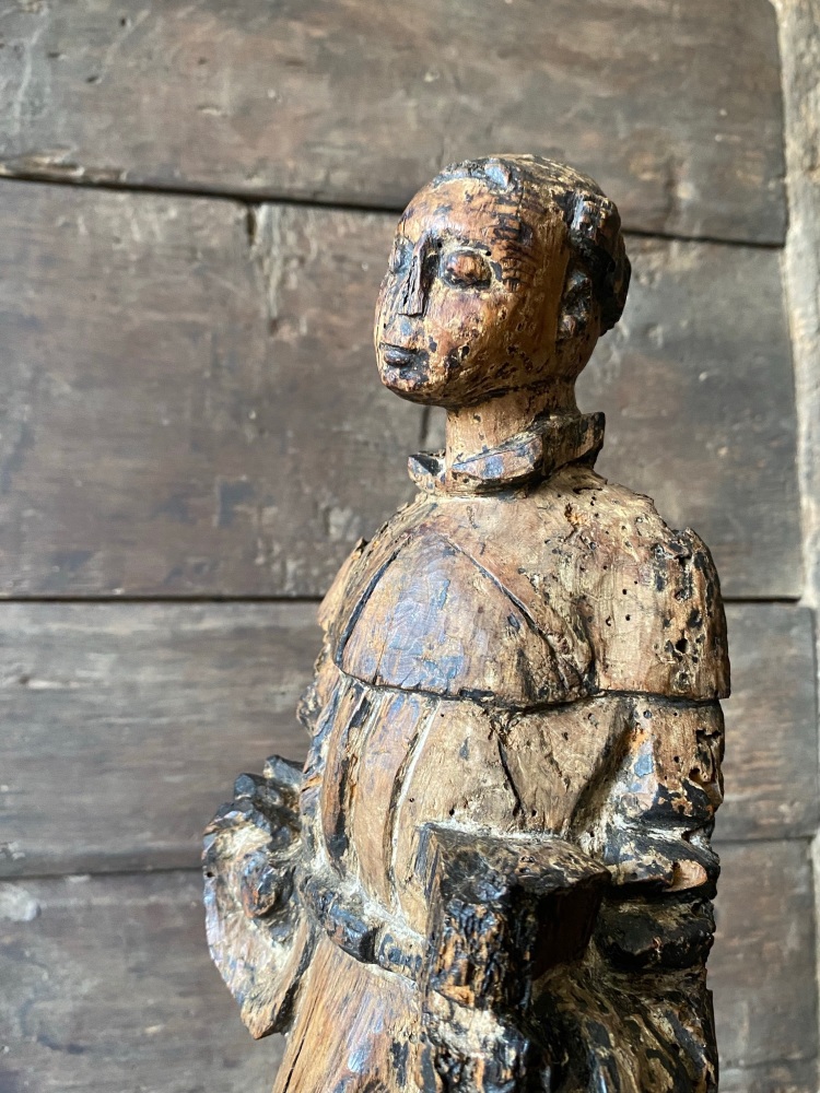 A 15th Century Carved Figure Depicting Saint Francis .