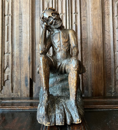 A 17th Century Carved Limewood Figure Of Christ Seated on the cold stone.