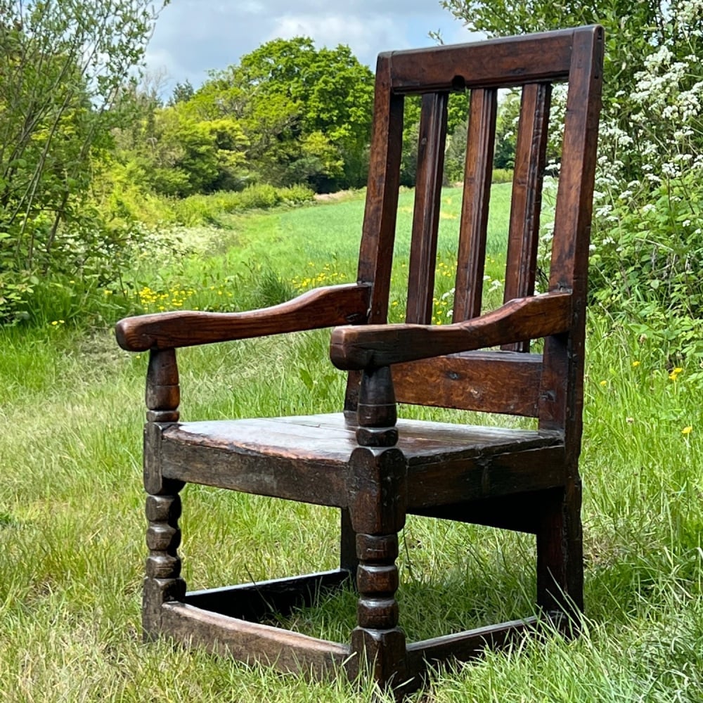 A Chunky 17th Century Welsh Mixed Wood Country Chair Of Wide Proportions.