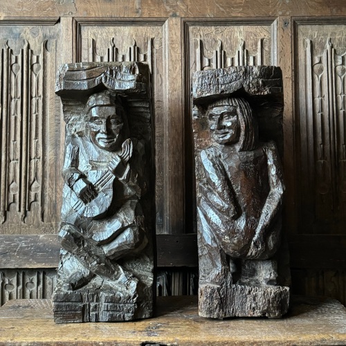 A Pair Of 17th Century Carved Oak Corbels Depicting A Minstrel And A Man Wi