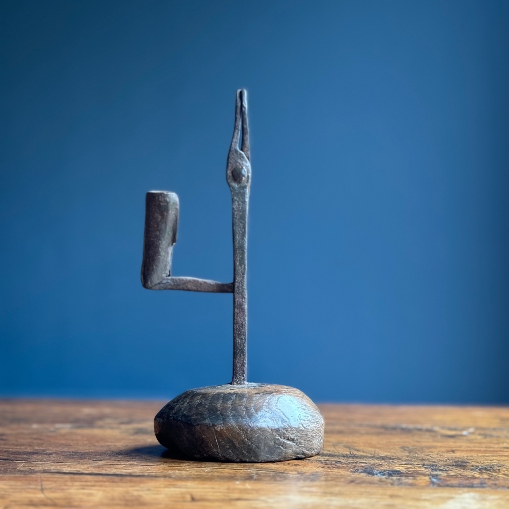 A Late 18th Century Iron Rushnip on an oak base.