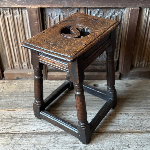 A Rare Charles II oak joint stool with an unusual pierced seat.