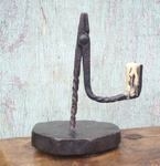 A 17th century iron rushnip on a board base